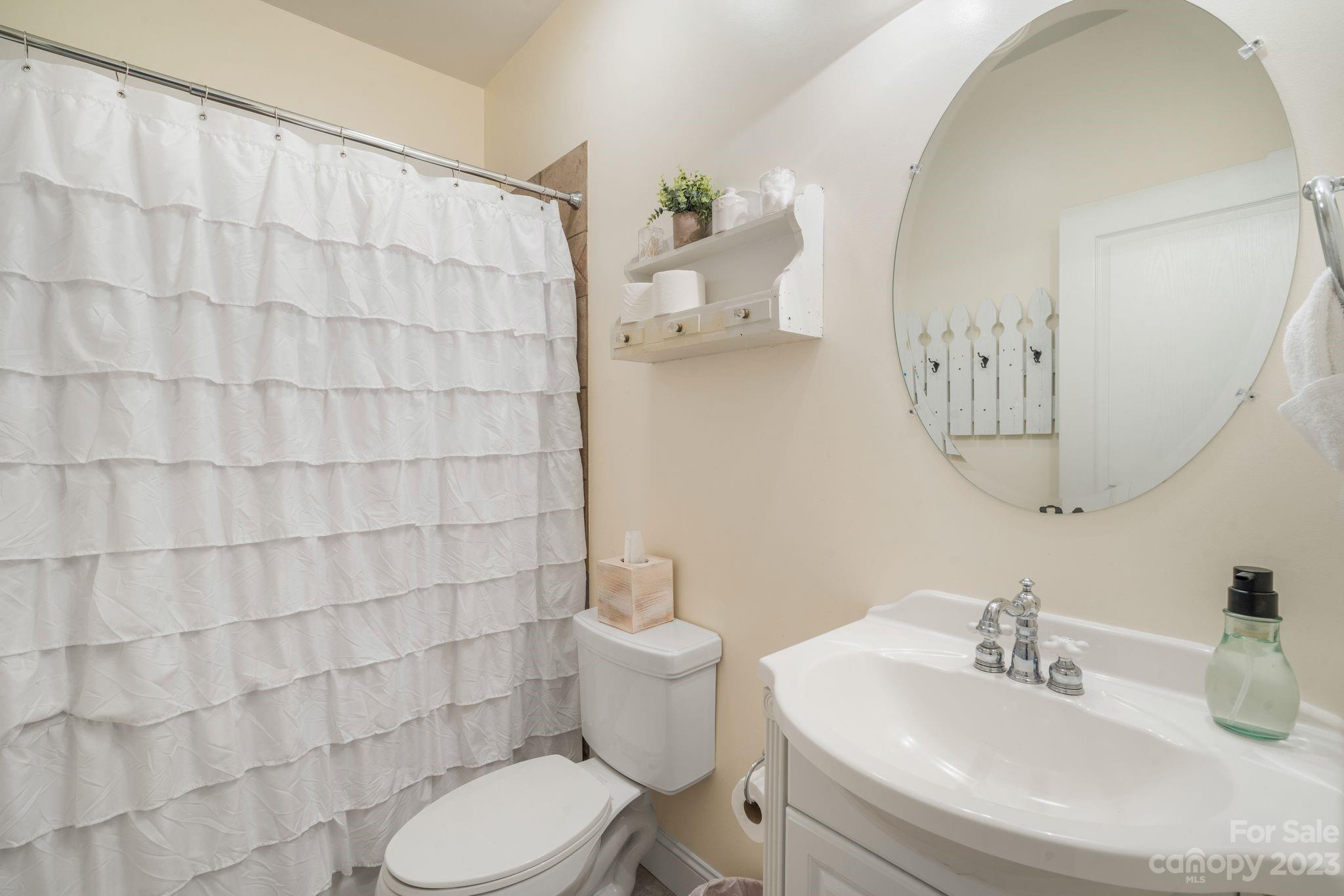 874 Burney Mountain Road Fletcher, NC 28732 - Photo 33 of 37 a bathroom with a sink toilet and shower