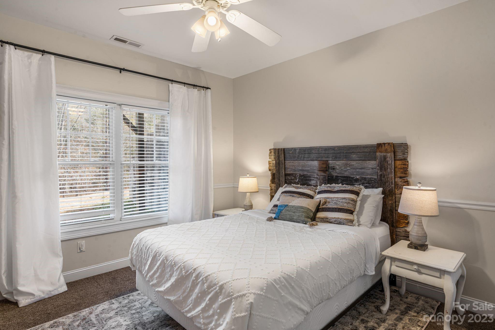 874 Burney Mountain Road Fletcher, NC 28732 - Photo 34 of 37 a bedroom with a bed and a window