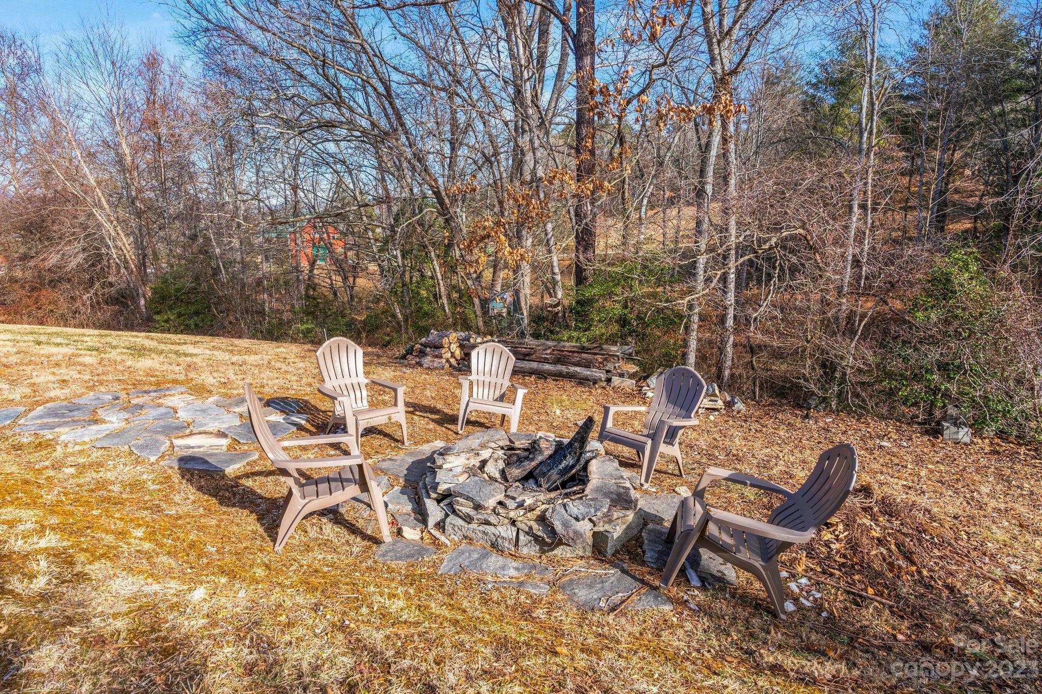 874 Burney Mountain Road Fletcher, NC 28732 - Photo 37 of 37 a view of a patio with table and chairs and couches with wooden fence