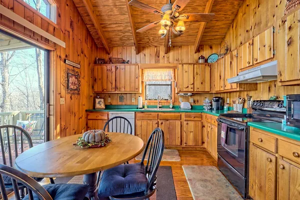 a view of a kitchen with granite countertop lots of wooden cabinets