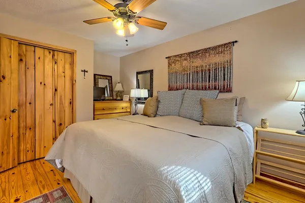 a bedroom with two beds and painting on the wall