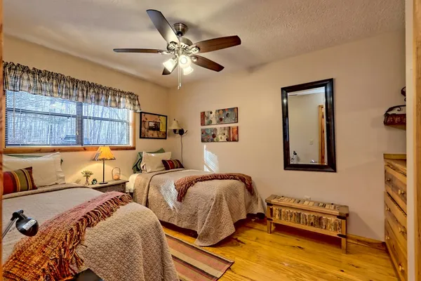 a bedroom with a bed and wooden floor