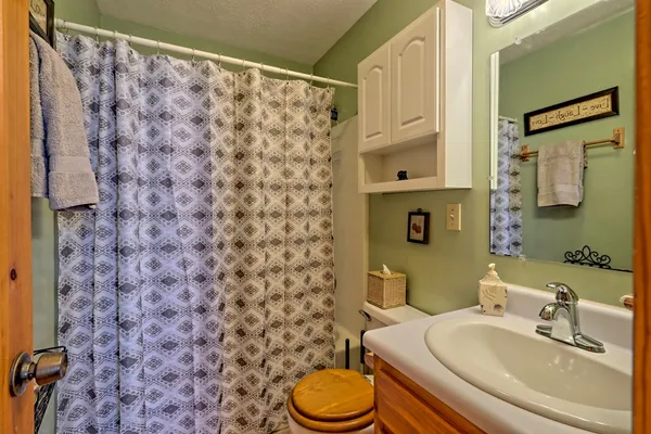 a living room with furniture a fireplace and wooden floor