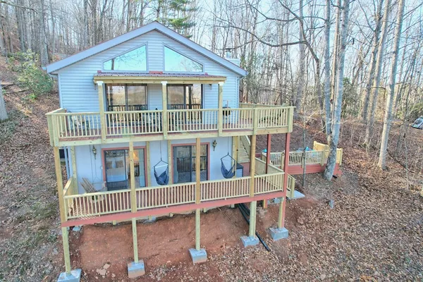 a view of a house with a yard and wooden fence
