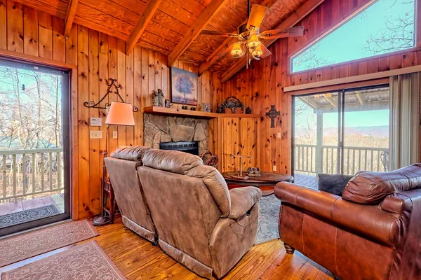 a living room with furniture a bed and a window
