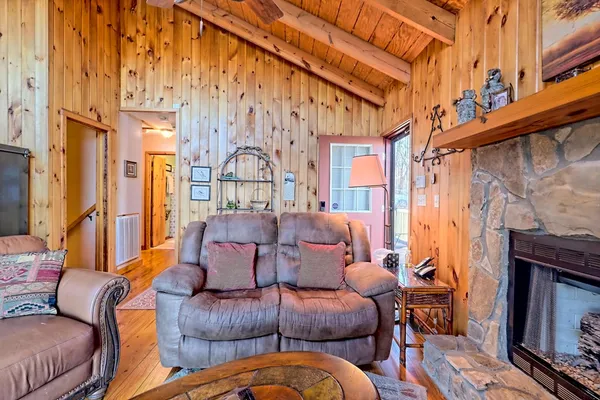 a living room with furniture a fireplace and a large window