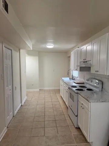 a kitchen with a sink cabinets and window