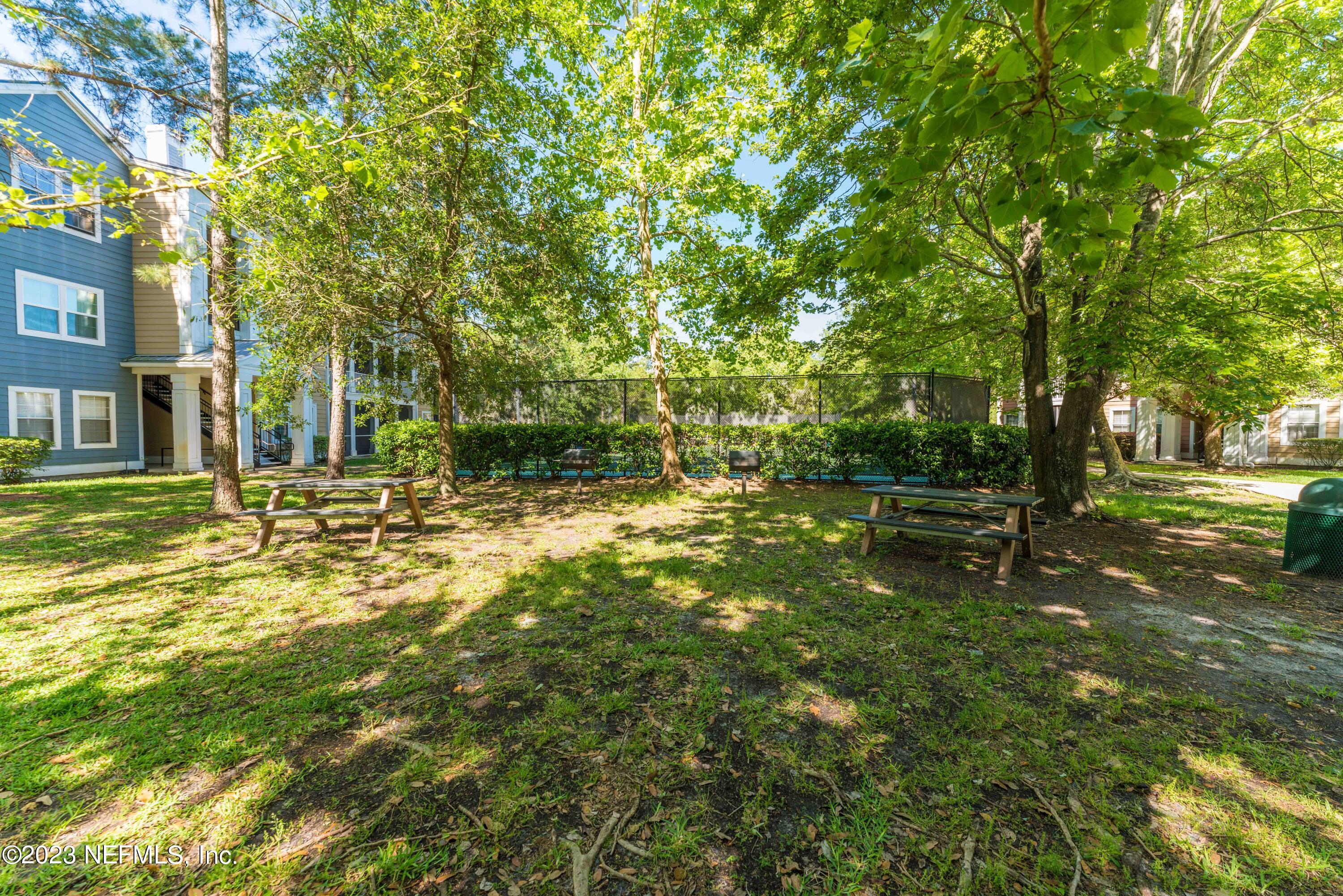 8550 Touchton Road, Unit 1136 Jacksonville, FL 32216 - Photo 43 of 53 a backyard of a house with lots of green space