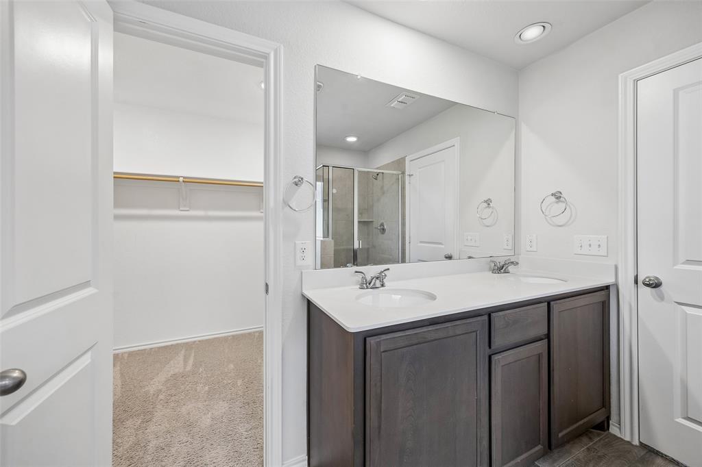 3807 Dogwood Road Melissa, TX 75454 - Photo 28 of 38 a bathroom with a sink a mirror and a vanity