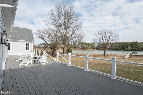 a view of a patio with chairs next to a yard