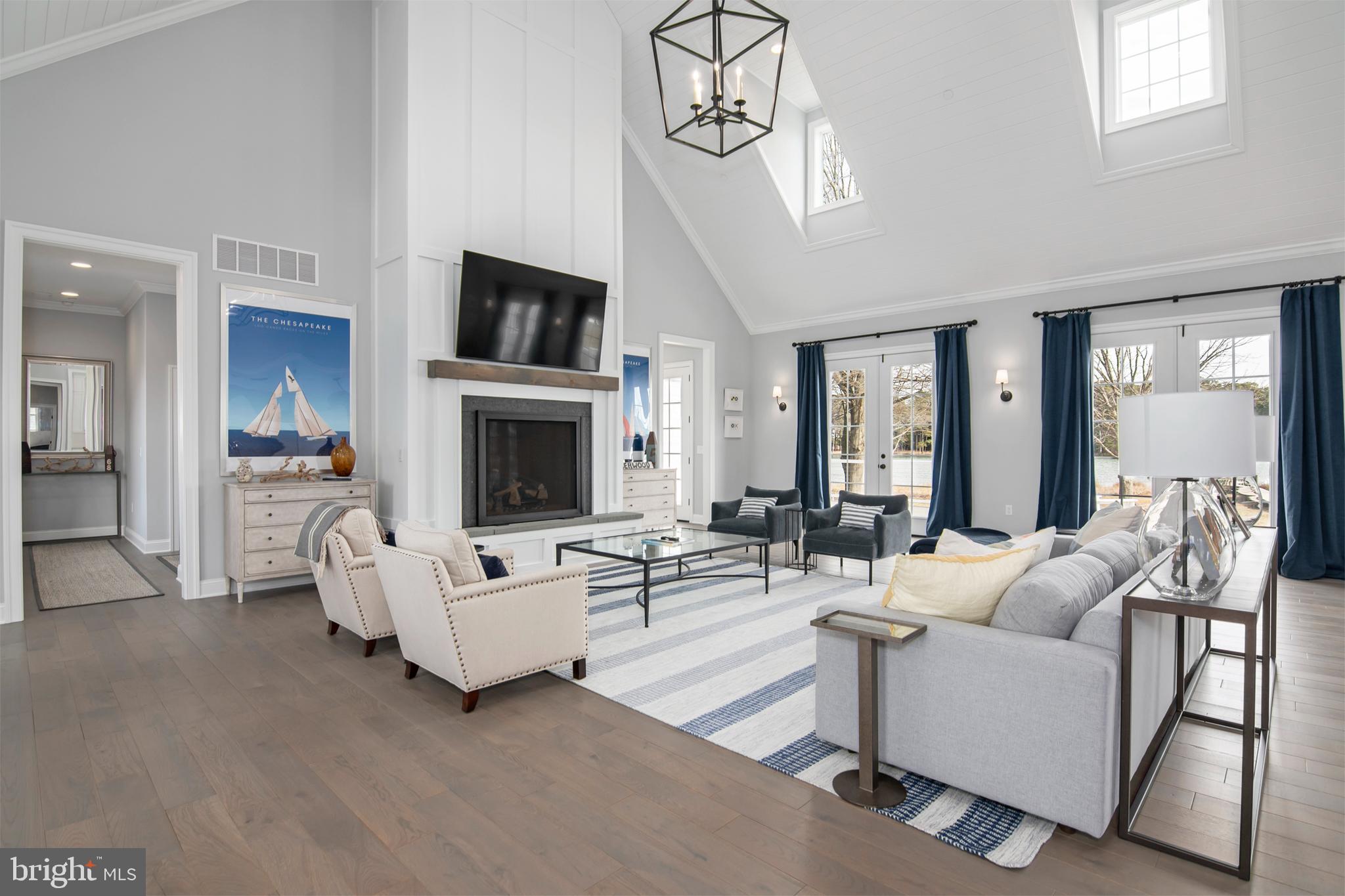 21825 Langdon Farm Road Sherwood, MD 21665 - Photo 29 of 47 a living room with furniture a fireplace and a flat screen tv