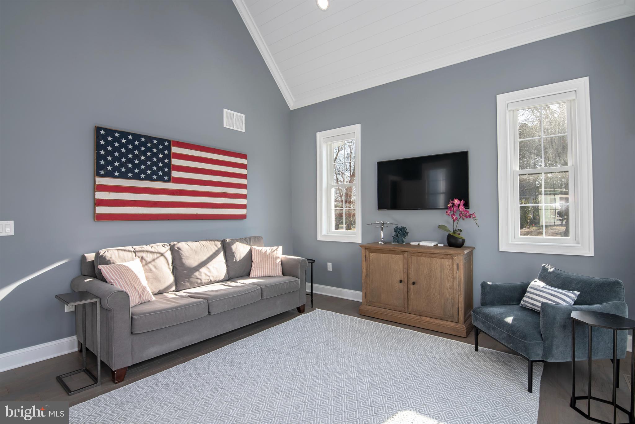 21825 Langdon Farm Road Sherwood, MD 21665 - Photo 32 of 47 a living room with furniture and a flat screen tv