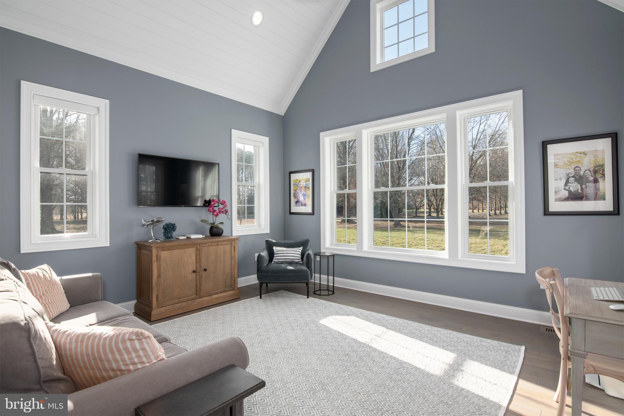 21825 Langdon Farm Road Sherwood, MD 21665 - Photo 33 of 47 a living room with furniture and a flat screen tv