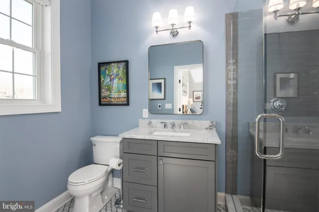 a spacious bedroom with a bed couch and a window