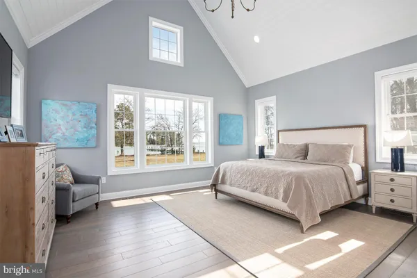 a bedroom with a large bed and a window