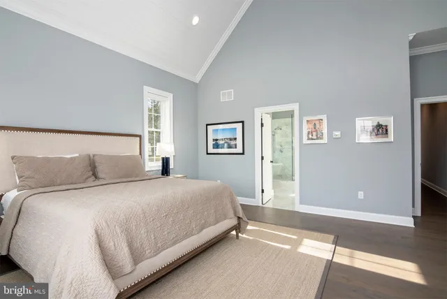 a bedroom with a bed and flat screen tv