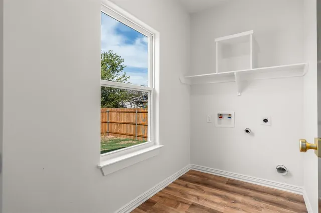 an empty room with a window and ceiling fan