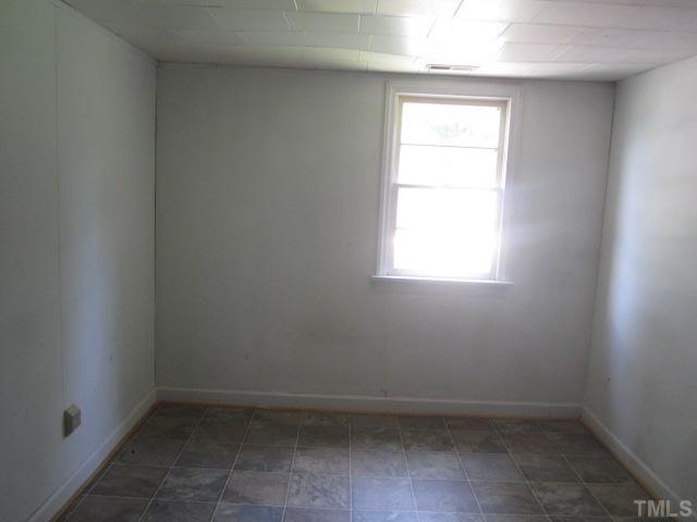 525 Devils Racetrack Road Four Oaks, NC 27524 - Photo 8 of 11 an empty room with a window