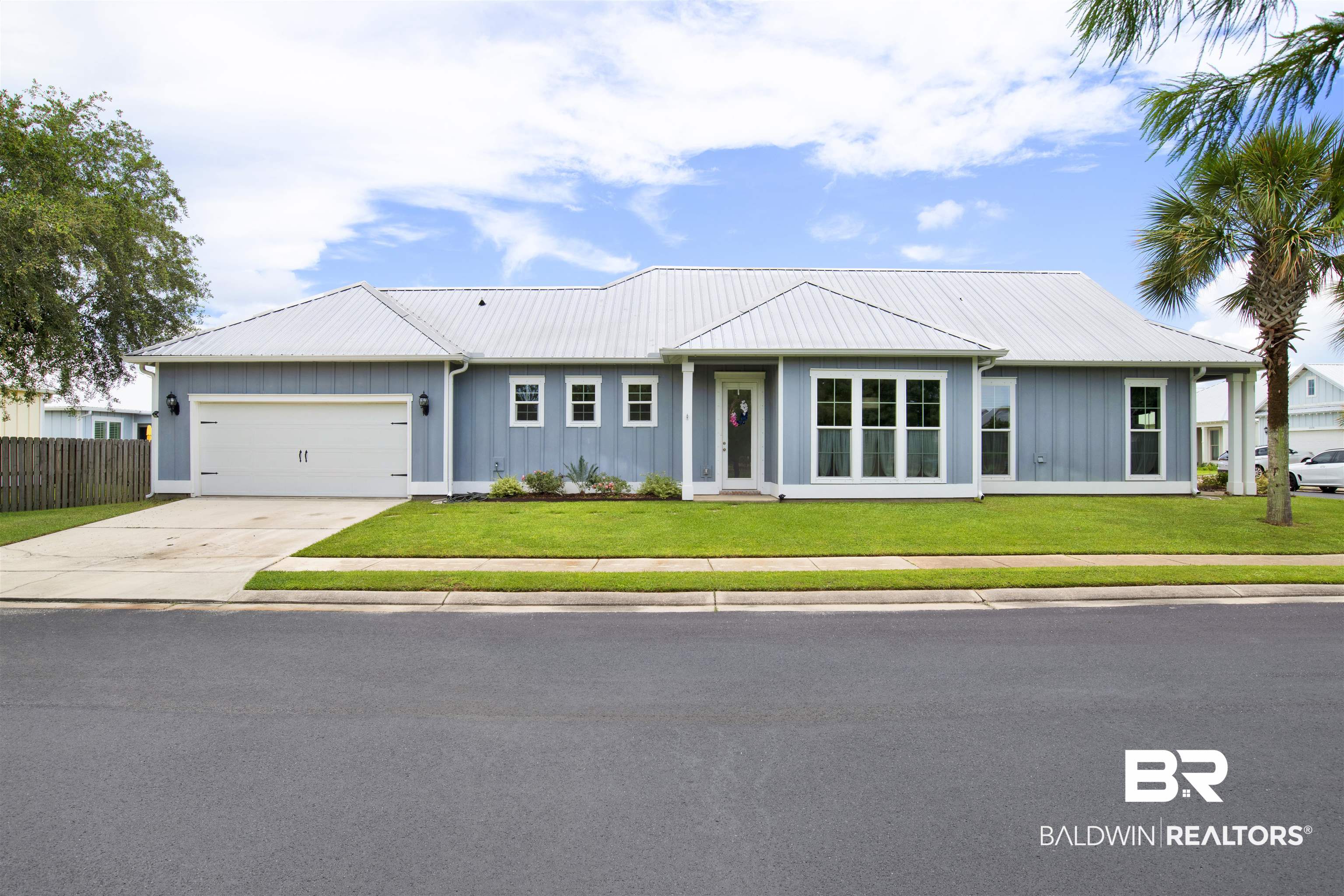 23893 Cypress Crossing Orange Beach, AL 36561 - Photo 2 of 22 Single story home with a garage, driveway, board and batten siding, and a metal roof