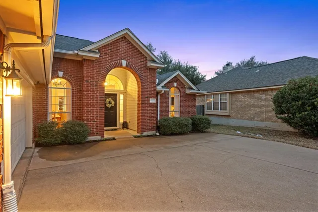 a view of a brick house with a large windows
