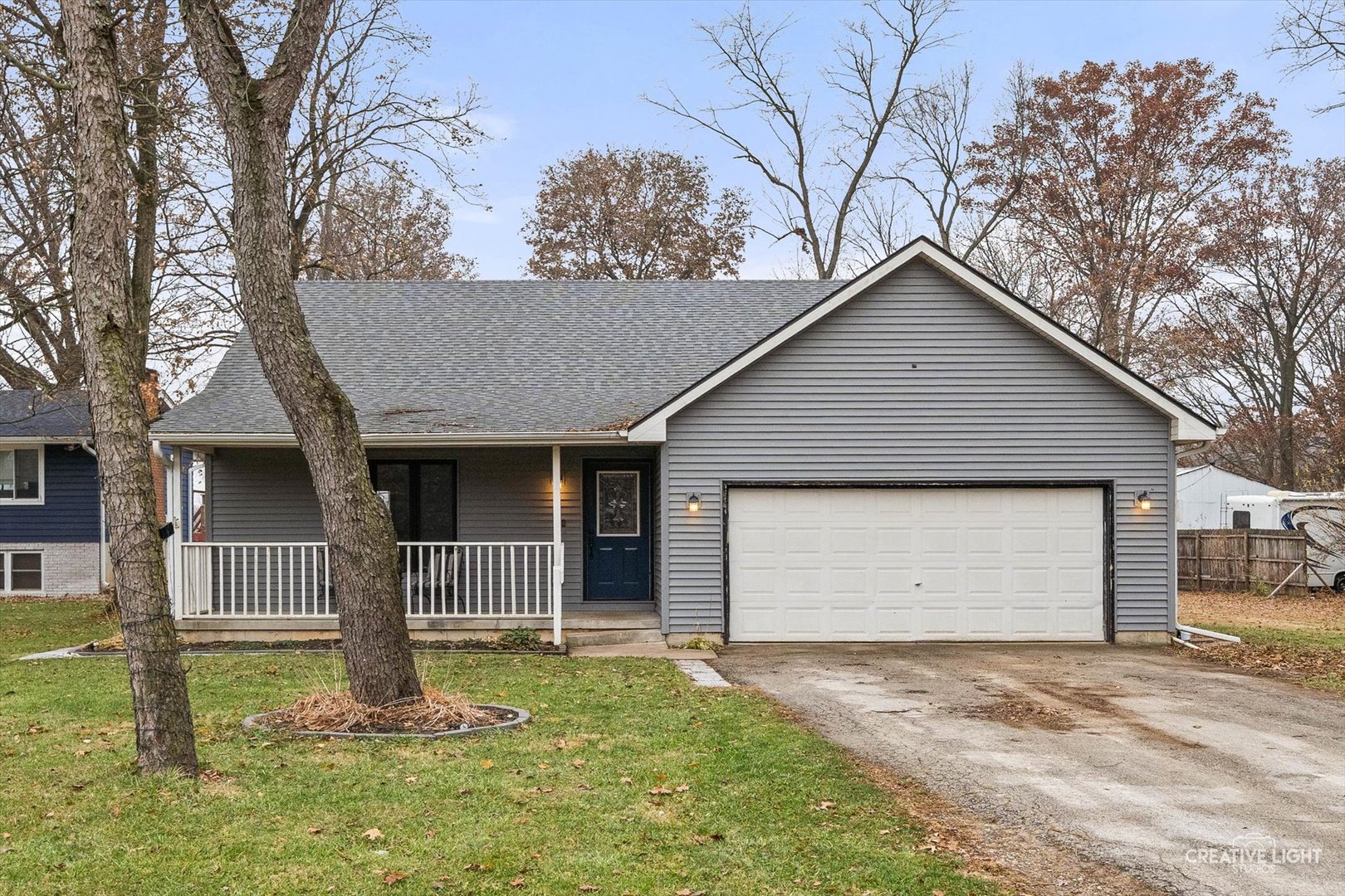 a front view of house with yard and garage