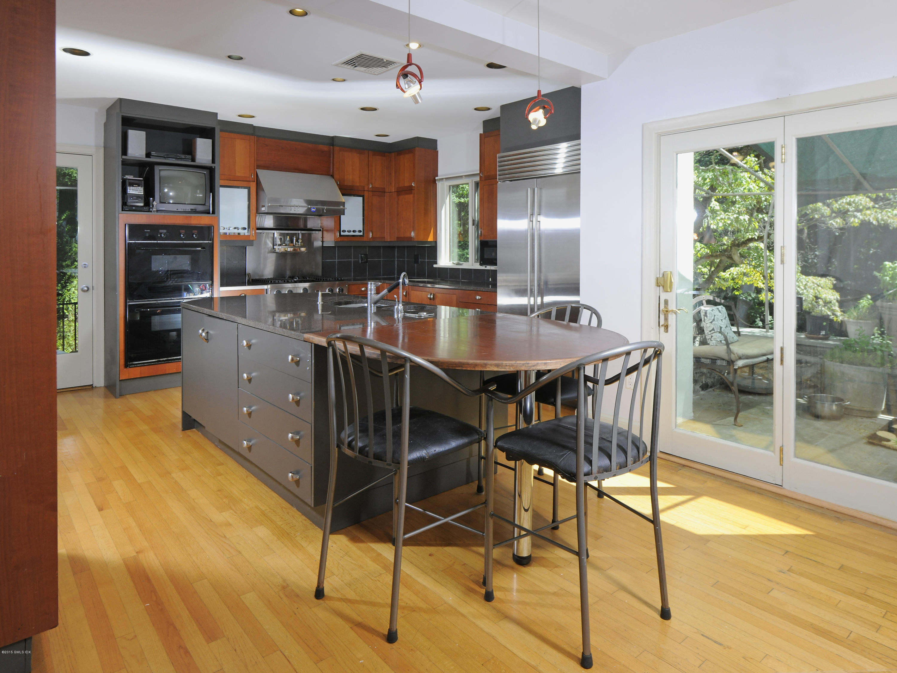 65 Overlook Drive Greenwich, CT 06830 - Photo 11 of 21 a kitchen with stainless steel appliances kitchen island granite countertop a table chairs sink and stove