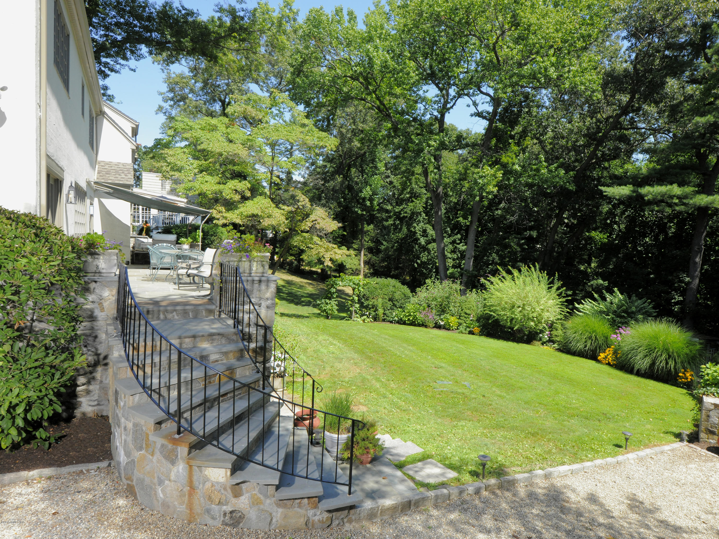 65 Overlook Drive Greenwich, CT 06830 - Photo 18 of 21 a view of a backyard with plants and a patio