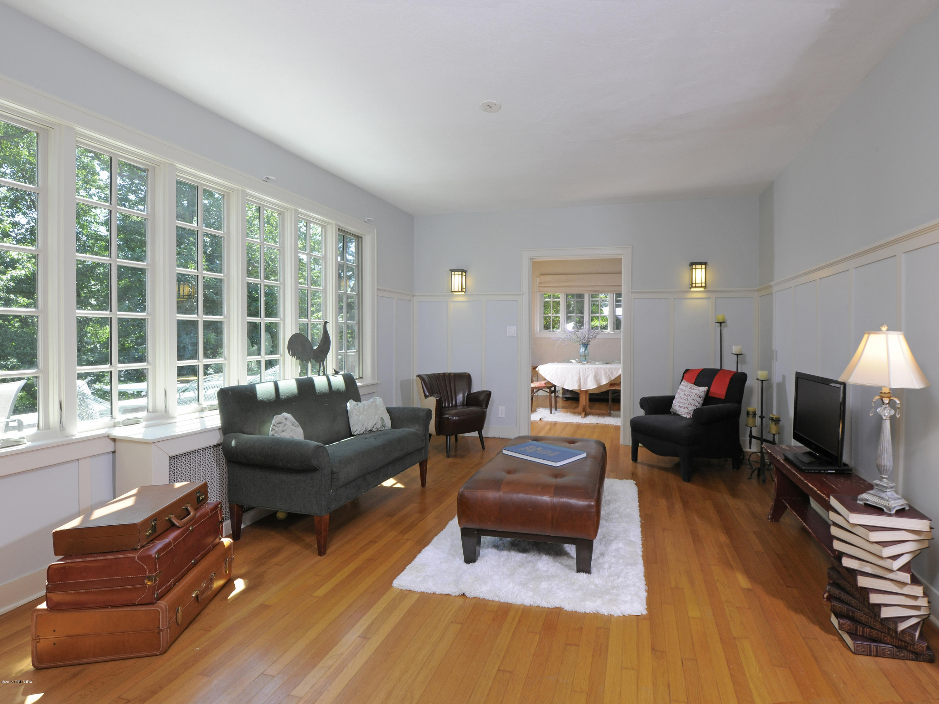 65 Overlook Drive Greenwich, CT 06830 - Photo 9 of 21 a living room with furniture a large window and a flat screen tv