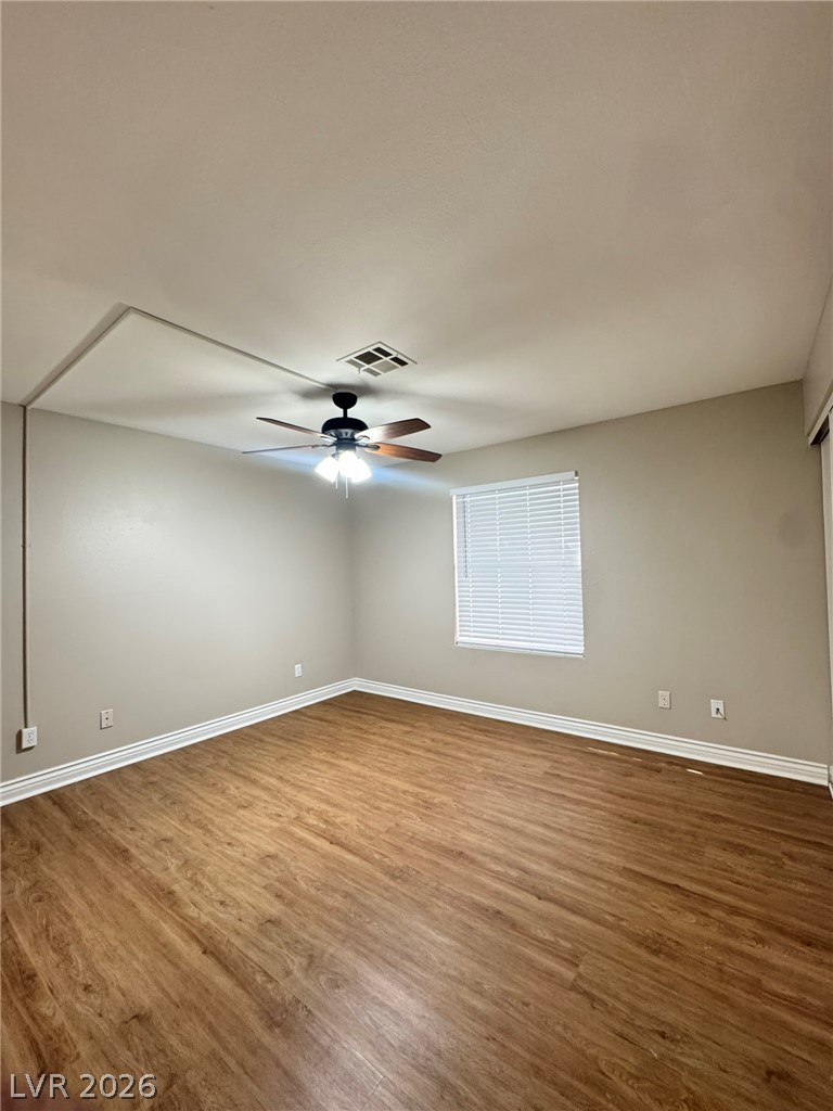5141 South Lindell Road, Unit 102 Las Vegas, NV 89118 - Photo 14 of 17 Hardwood-style flooring and a ceiling fan provide comfort in this generously sized room.