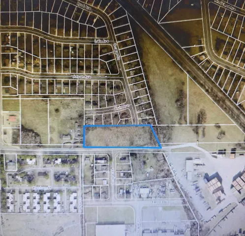 a yard with swimming pool and green space