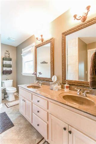 2670 Cooks Road Mount Juliet, TN 37122 - Photo 11 of 20 a bathroom with a granite countertop double vanity sink a mirror and a window