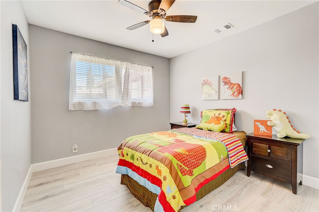 11124 Blue Jay Drive Riverside, CA 92505 - Photo 5 of 16 a bedroom with a bed and a chandelier