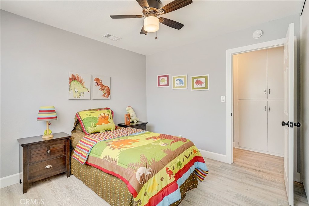 11124 Blue Jay Drive Riverside, CA 92505 - Photo 9 of 16 a bedroom with a bed and wooden floor