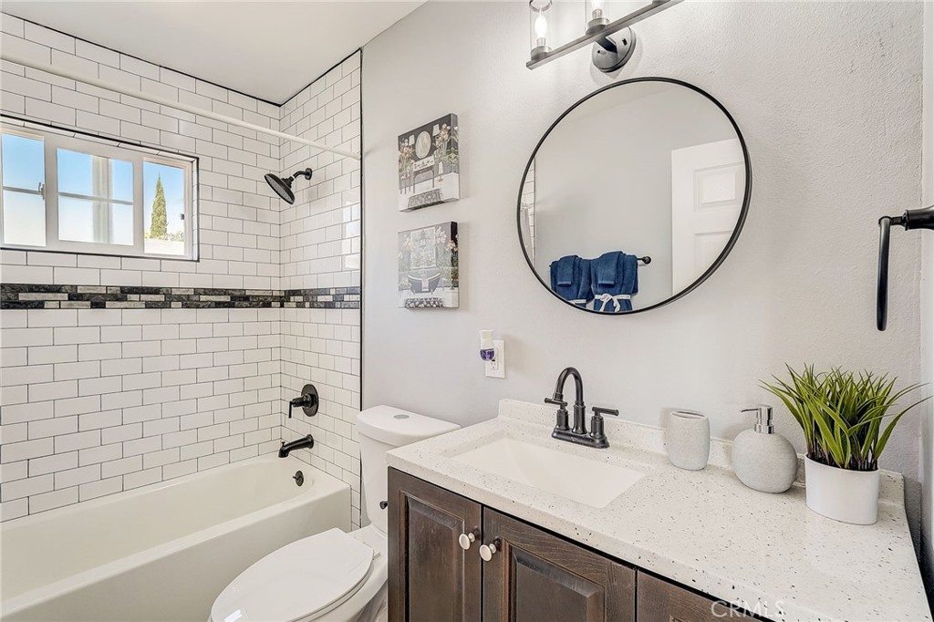 11124 Blue Jay Drive Riverside, CA 92505 - Photo 10 of 16 a bathroom with a sink a mirror a toilet and a bathtub