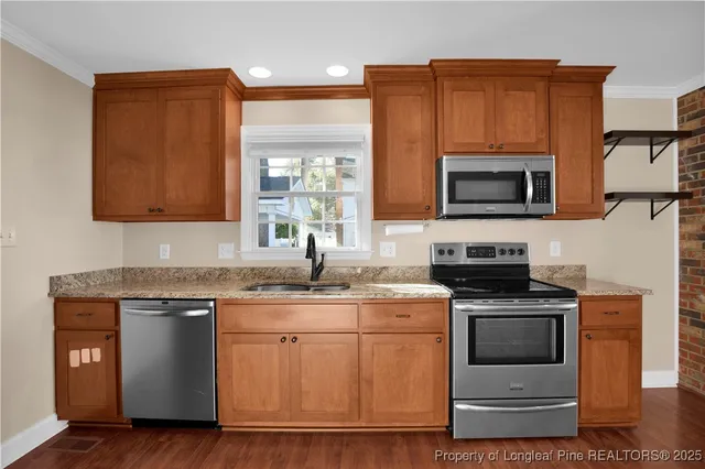 a kitchen with a sink stove and microwave
