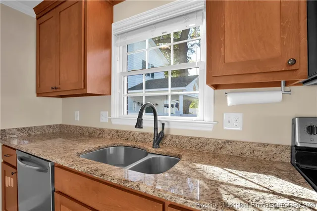 a kitchen with granite countertop a sink and a stove