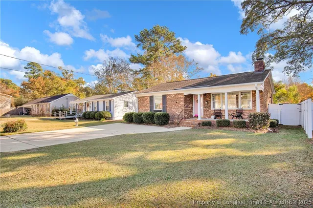 a view of a house with swimming pool and sitting area