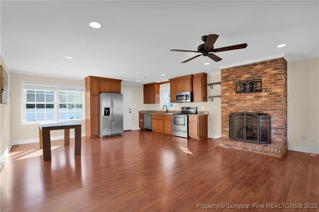 a view of a kitchen with cabinets and wooden floor