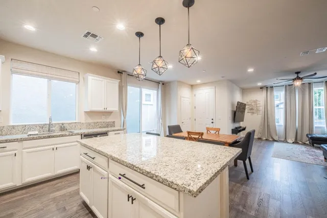 a metallic refrigerator freezer sitting in a kitchen