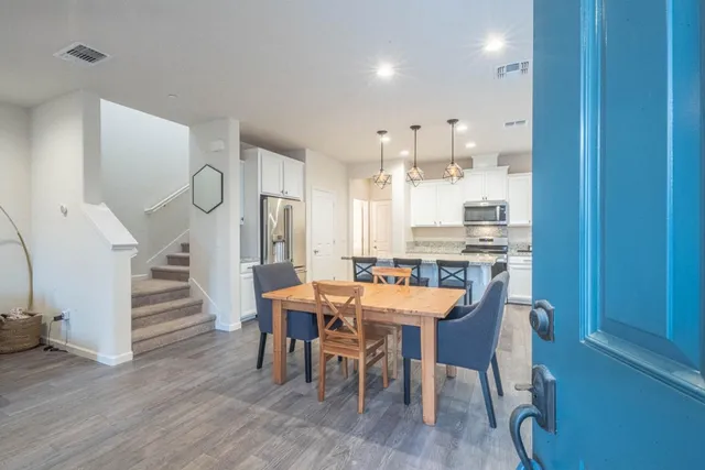 a view of a dining room with furniture and wooden floor