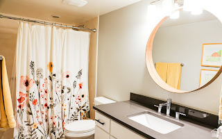 578 High Bench Road Alpine, UT 84004 - Photo 32 of 39 Bathroom featuring a vanity with an undermount sink and a dark countertop, an overhead lighting fixture, and a wall-mounted round mirror