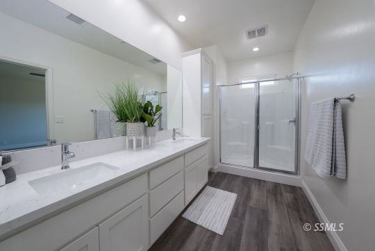 327 Abigail Street Ridgecrest, CA 93555 - Photo 24 of 35 a bathroom with a double vanity sink and mirror