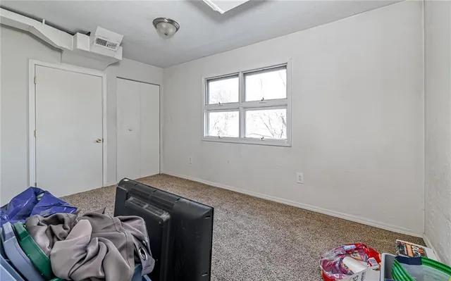 a bedroom with bed and a chair