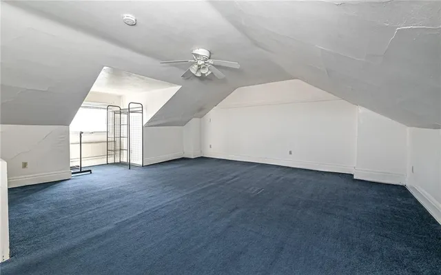 a view of a livingroom with an empty space and a ceiling fan
