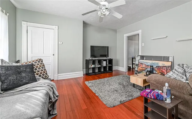 a bedroom with furniture and a flat screen tv