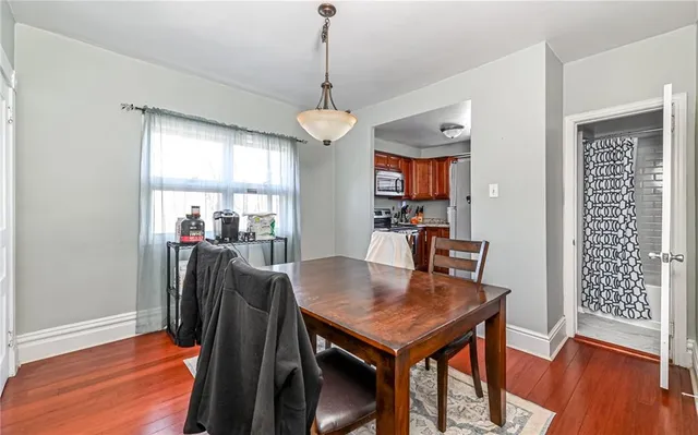 a view of a dining room with furniture window and wooden floor