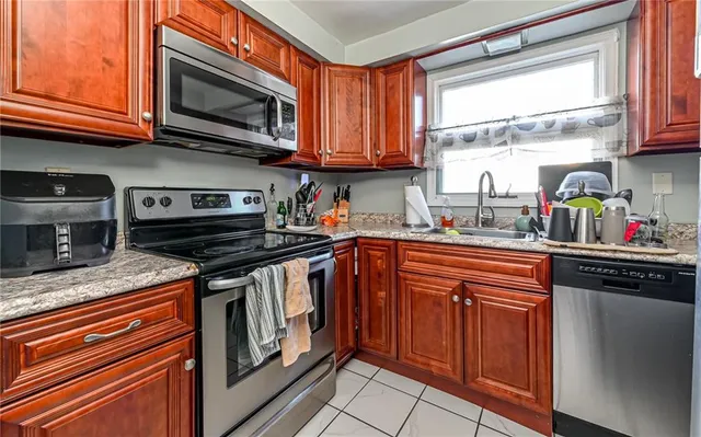 a kitchen with stainless steel appliances granite countertop a stove sink microwave and cabinets