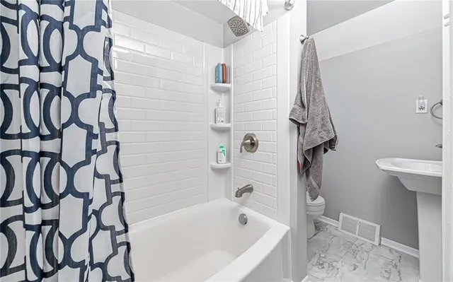 a bathroom with a bathtub and shower