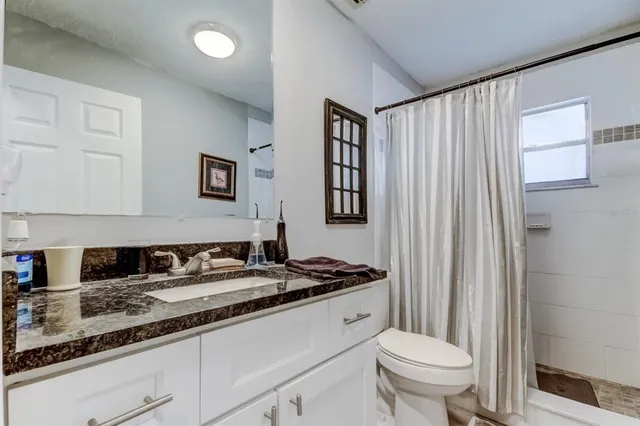 a bathroom with a toilet a sink and a mirror