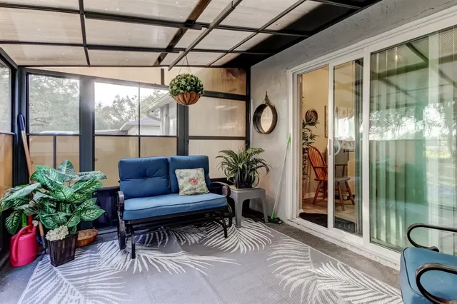 a view of house with outdoor space and trees in the background